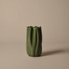 Green textured vase with ribbed design, featuring a fluted top against a neutral background. Ideal for modern decor.