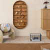 Wooden bookshelf with rounded edges, neutral walls, beige armchair with colorful pillow, and a blue wire basket.