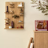 Wooden display shelf showcasing earthy tones, vibrant accents, and playful patterns against a neutral wall.
