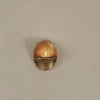 Brass wall candle holder with a reflective golden finish and smooth oval shape. 
