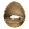 Egg-shaped bronze candle holder with a textured finish and a smooth, white candle. Elegant golden hues and modern design.