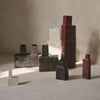 "Artistic vases in gray, green, black, white, and terracotta, featuring unique geometric patterns and textures."