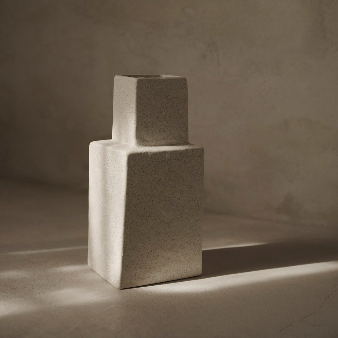Textured beige vase with minimalistic geometric shapes, showcasing a subtle, earthy color palette.