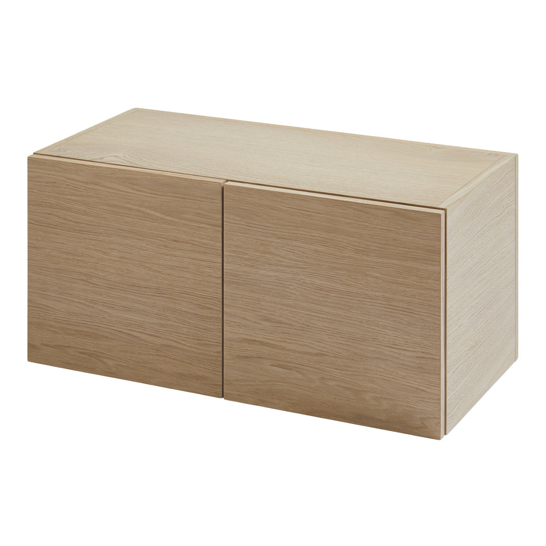 Light oak wooden storage cabinet with a smooth, minimalistic design and natural grain pattern.