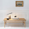 Natural wood coffee table with a smooth finish, featuring a minimalist design in light brown tones. Elegant, contemporary style.