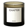 Black glass candle holder with an elegant beige label, subtle color gradient, and minimalist design.