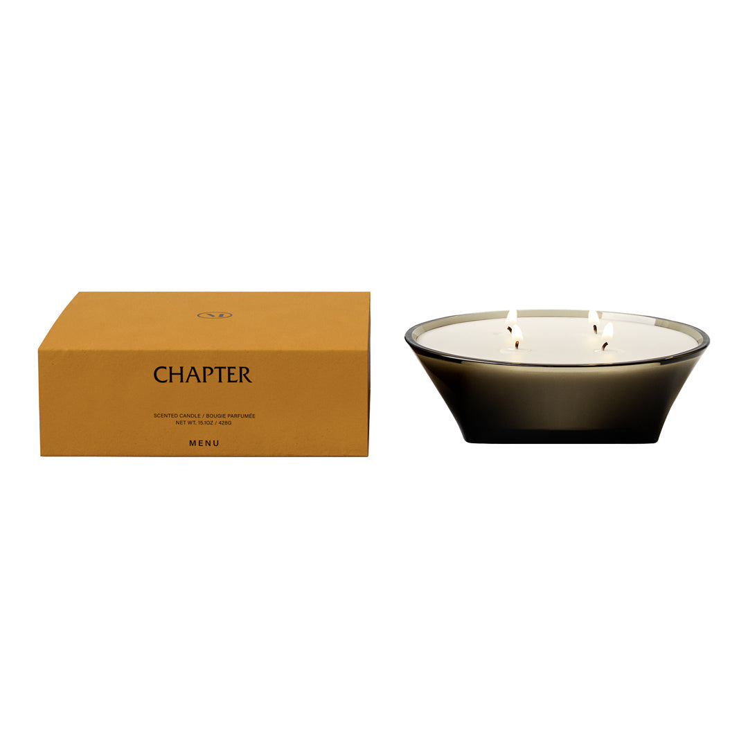 Sleek black glass candle holder with three wicks, accompanied by a warm, earthy brown box. Elegant and modern design.