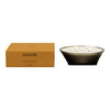 Sleek black glass candle holder with three wicks, accompanied by a warm, earthy brown box. Elegant and modern design.