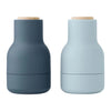 "Set of two vases in dark slate gray and soft pastel blue, featuring matte finishes and natural wood tops."