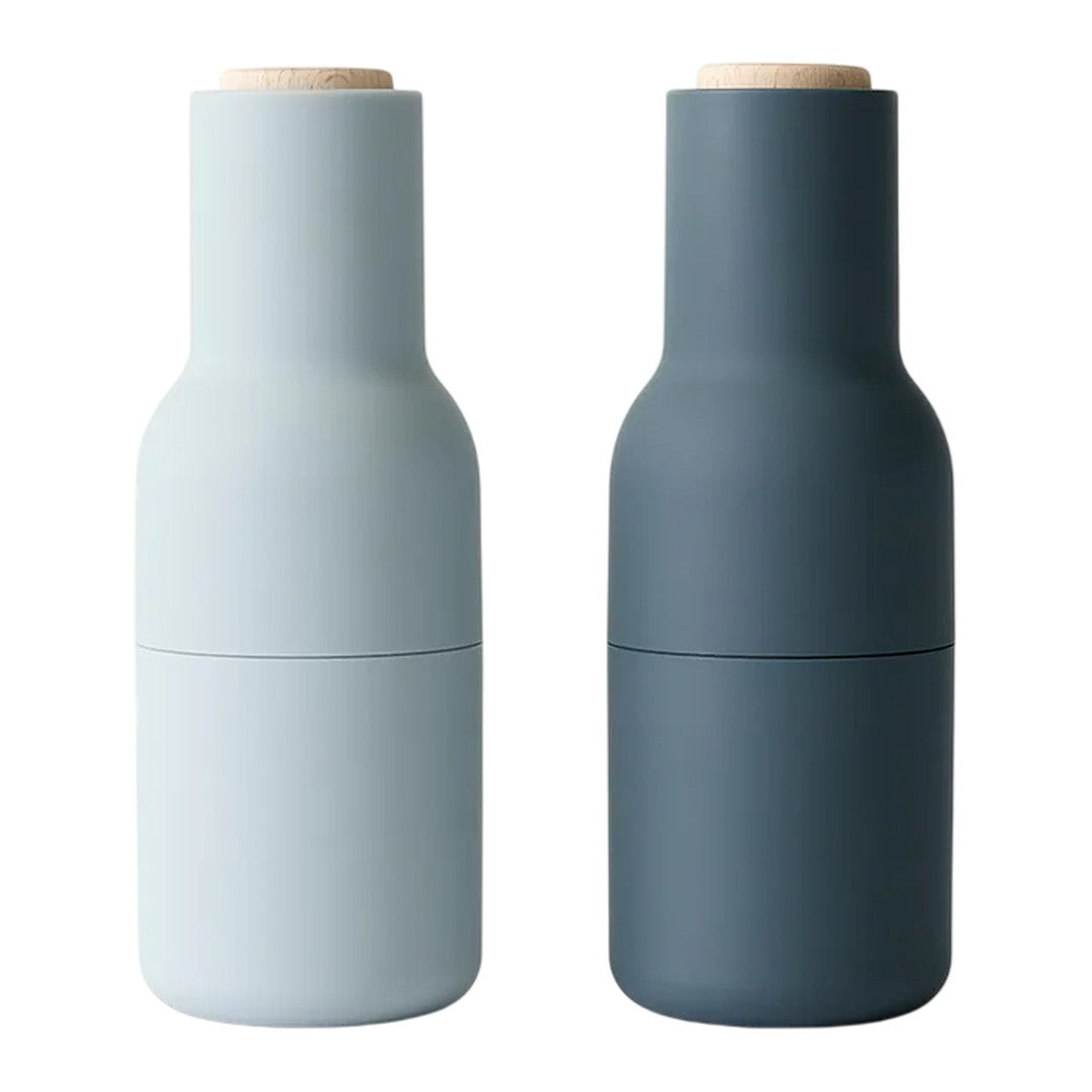 Two matte finish bottle-shaped containers in light blue and dark gray, featuring wooden lids. Modern and minimalist design.