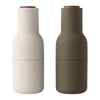 Stylish salt and pepper shakers in matte white and olive green, featuring a natural wood top. Modern minimalist design.