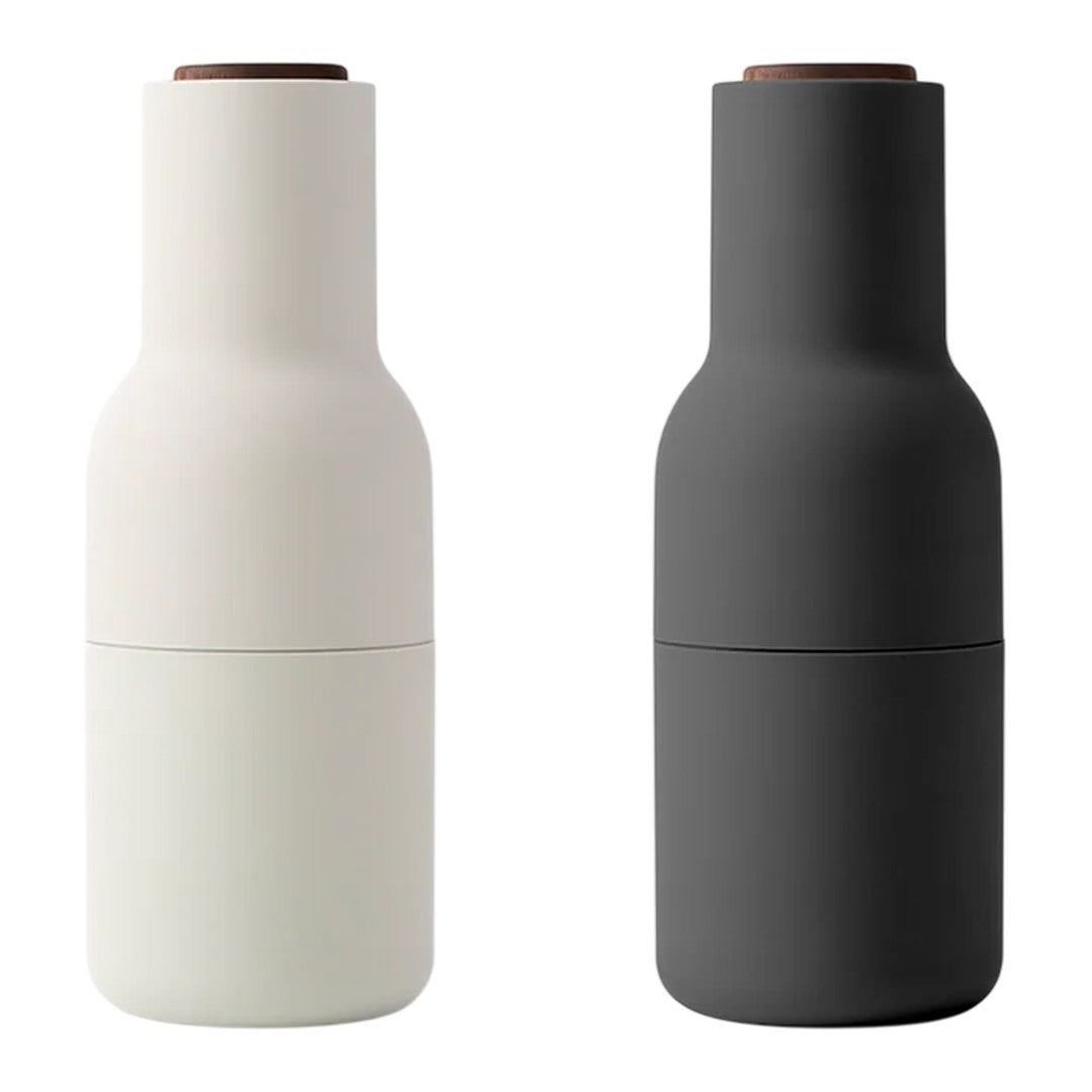 "Two sleek bottles in matte white and matte black with wooden accents, showcasing modern design and minimalistic patterns."