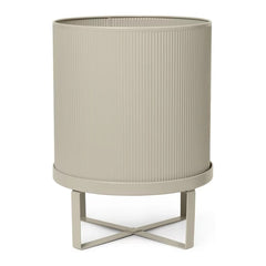 "Neutral beige planter with ribbed texture and minimalist metal stand."