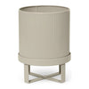 Beige ribbed planter with a stylish stand, featuring subtle texture and a modern design. Perfect for any decor.