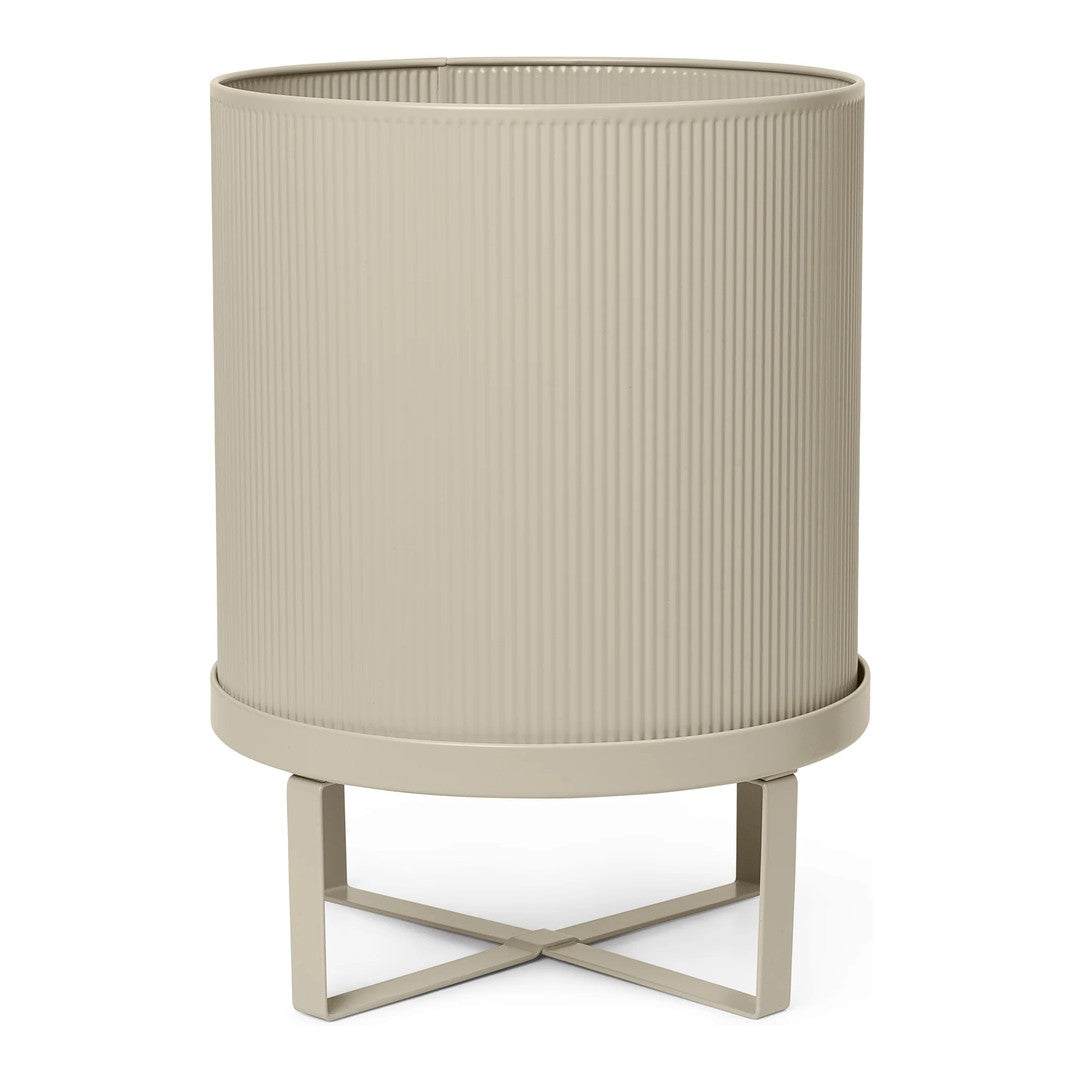 Beige ribbed planter on a cross-legged metal stand, textured design adds modern elegance to any space.