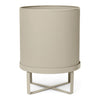 Beige ribbed planter on a cross-legged metal stand, textured design adds modern elegance to any space.