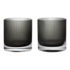 Set of two glass cups in smoky gray with elegant vertical ribbed patterns and clear bases.