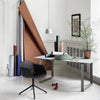 Modern workspace featuring soft mint green, rich brown, muted blue, and sleek black elements with subtle natural accents.