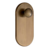 Brushed antique brass door knob with a smooth, oval plate design and round knob for a classic, elegant look.