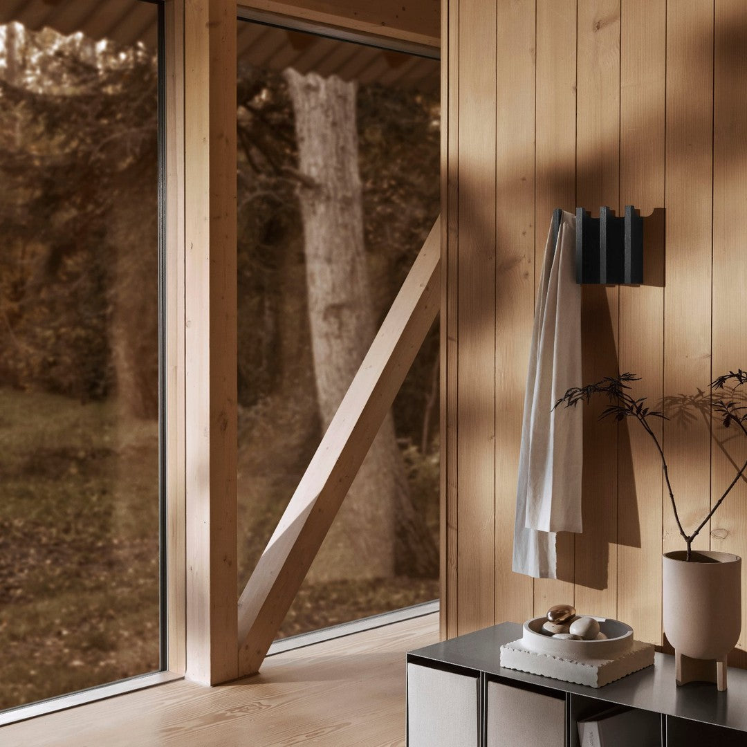 Warm wooden tones with a nature-inspired palette; soft whites and muted blacks create a serene, modern aesthetic.