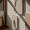 Textured neutral wall art in soft beige and creamy tones, featuring geometric shapes and a modern aesthetic.