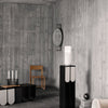 Modern decor featuring a gray wood wall, black and white furniture with curved patterns, and minimalist design elements.