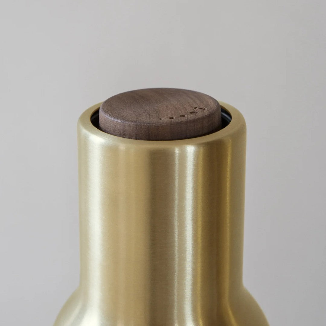 Brushed brass bottle neck with a dark walnut top, showcasing modern elegance and simple design.