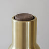 Brushed brass bottle neck with a dark walnut top, showcasing modern elegance and simple design.