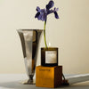 "Elegant gray vase, purple flower, and amber candle box, creating a stylish and sophisticated color palette."