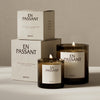 "Brown glass candle holders with cream labels, stacked boxes in soft beige, minimalist design, elegant patterns."