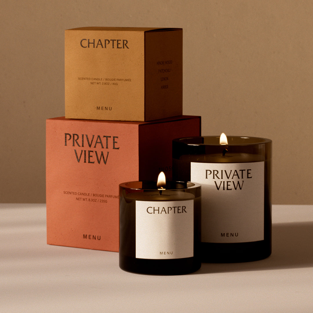 Candle packaging in earthy tones: warm amber, terracotta, and deep black, with elegant minimalistic labels.