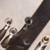 "Clear glass cups casting shadows on a textured, light gray surface with a hint of golden metal accents."