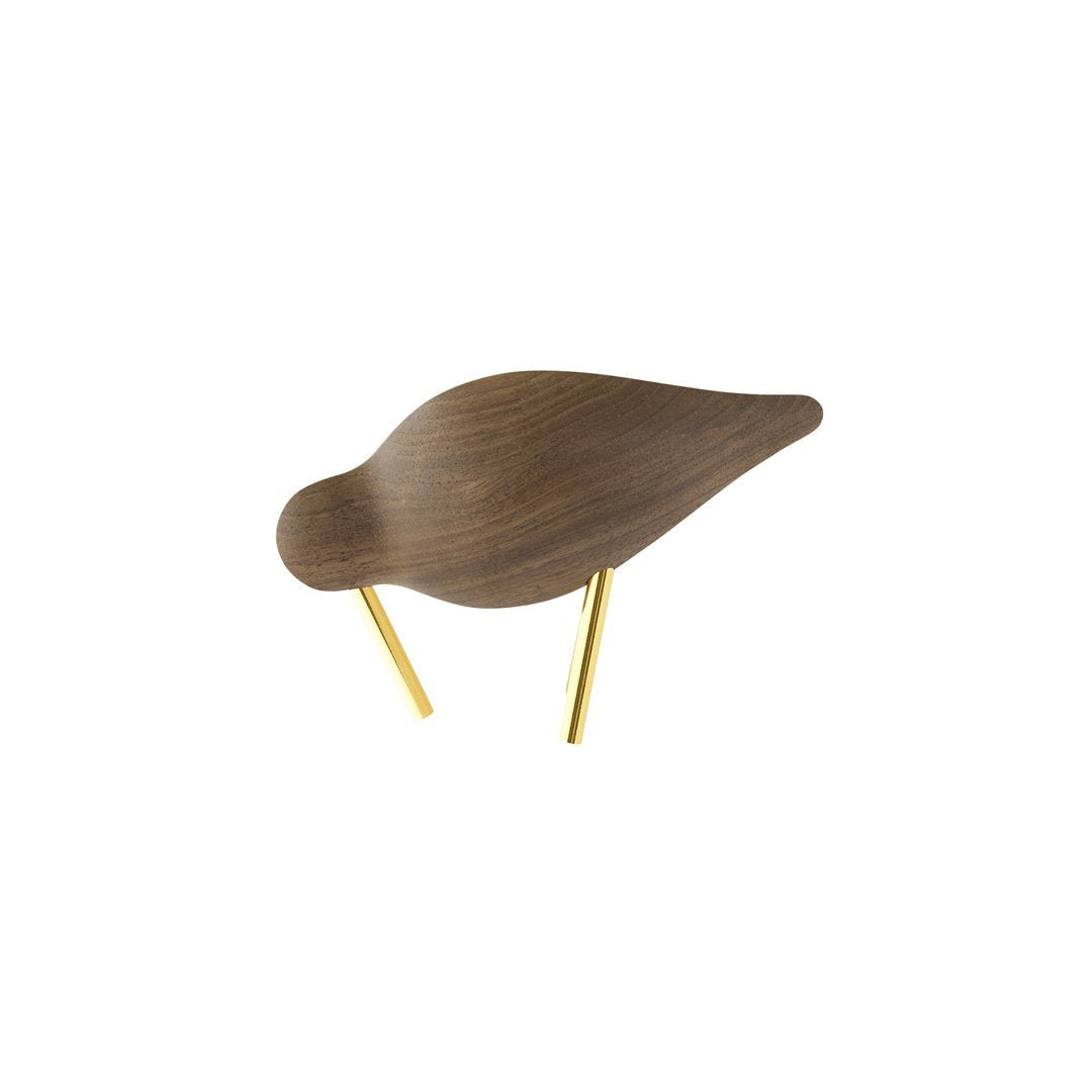Wooden bird sculpture in rich brown with sleek gold legs, showcasing a minimalist design and smooth curves.