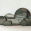 Green and beige decorative trays with abstract patterns and varying shapes, perfect for modern home decor.