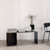 "Stylish black coffee table with a minimalist design, featuring sleek lines and a smooth surface."