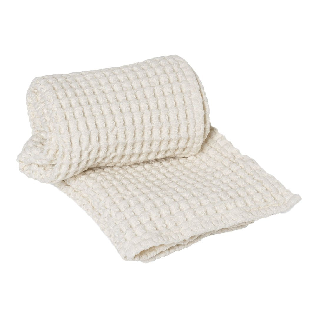 Light ivory textured blanket with a classic woven pattern, adding warmth and elegance to any space.