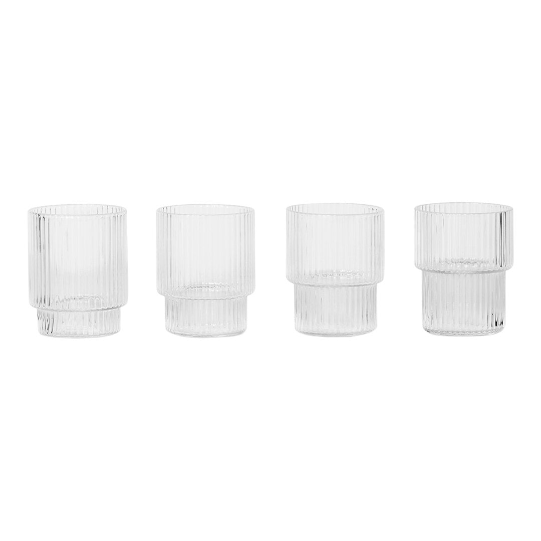 Set of four clear glass tumblers with vertical ribbed patterns, showcasing a modern, minimalist design.