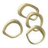 Set of four textured gold rings with varied circular shapes and smooth edges, showcasing a modern and elegant design.