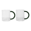 Clear glass mugs with green handles, featuring a sleek, modern design and seamless transparency.