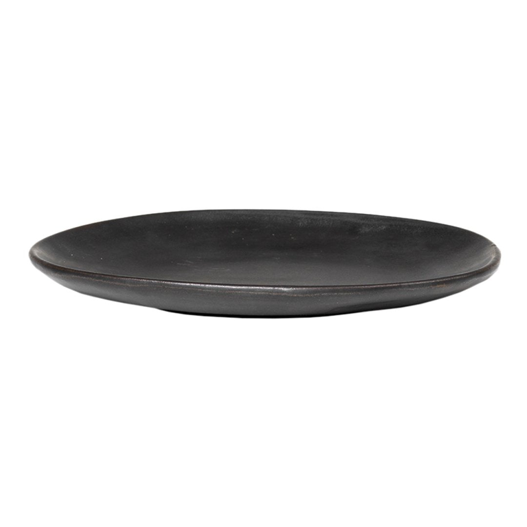 Black ceramic plate with a smooth, matte finish and a minimalist design, perfect for stylish table settings.