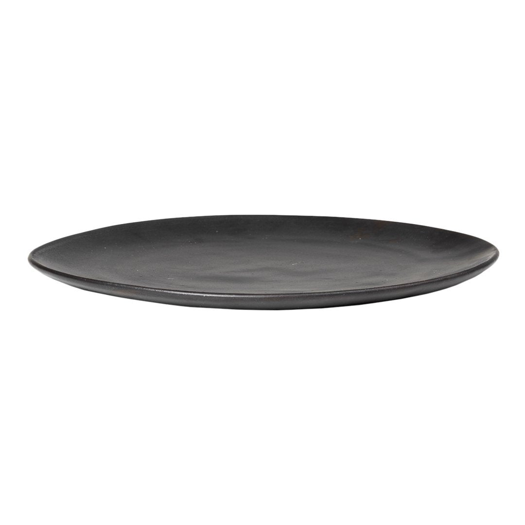 Black ceramic plate with a smooth, matte finish and subtle, natural variations in color and texture.
