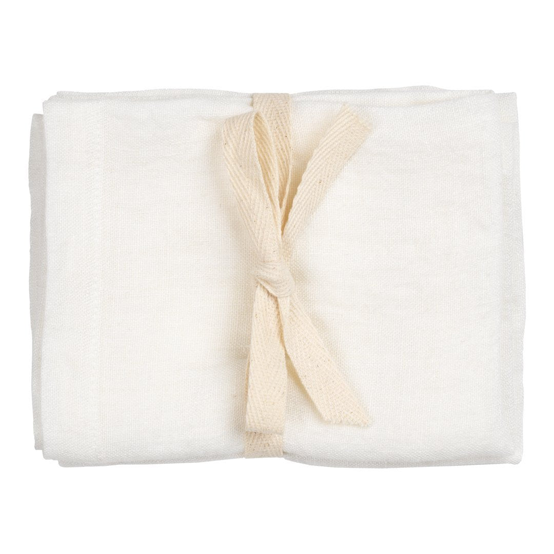 Soft cream muslin blanket tied with a natural linen ribbon, featuring a smooth, solid texture. Perfect for cozy comforts.