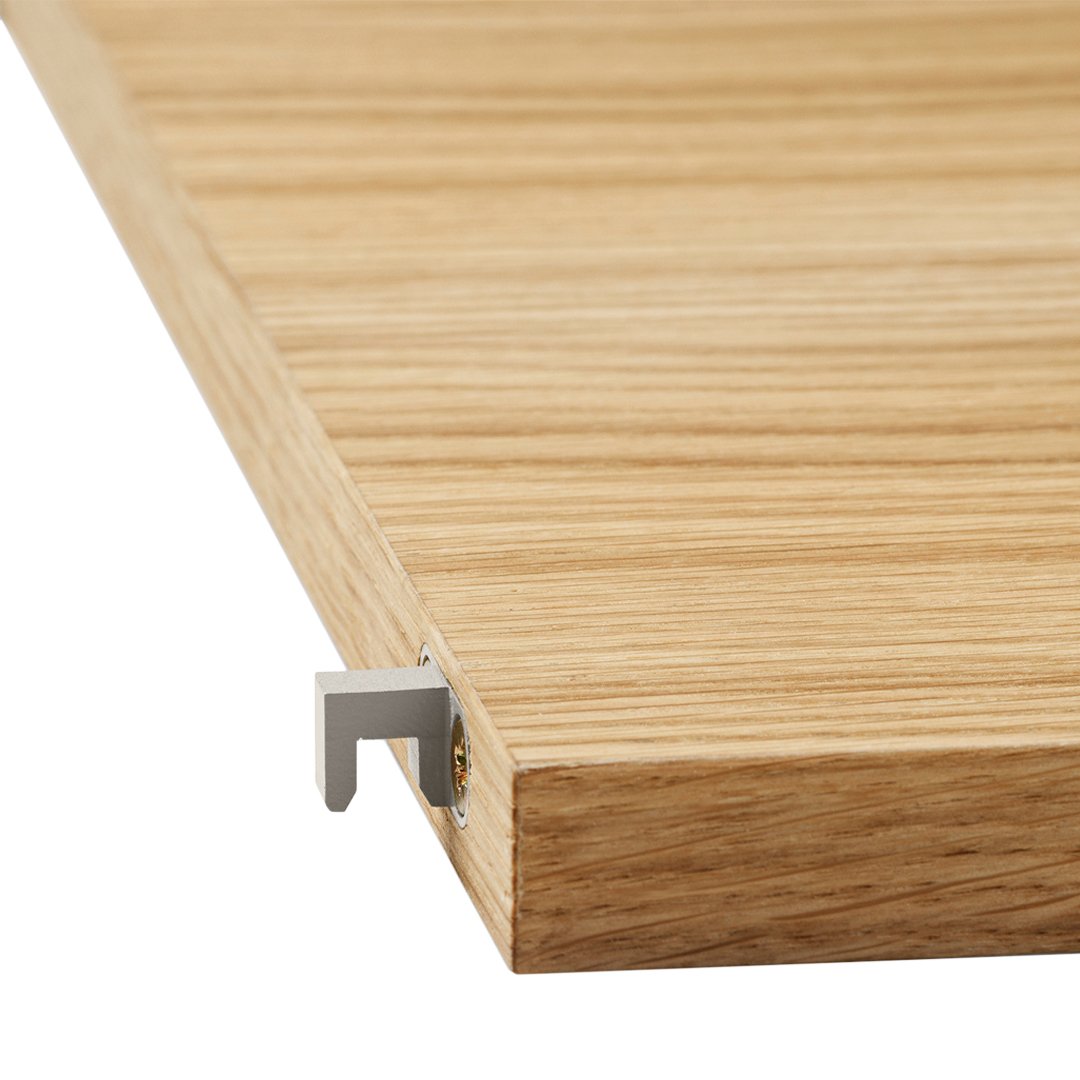 Light oak wooden shelf edge with a smooth grain pattern and silver metal bracket. Ideal for modern decor.