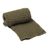 Olive green rolled textured blanket with a cozy waffle pattern, perfect for home décor and comfort.