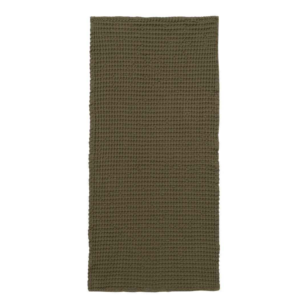 Olive green textured blanket with a checkered pattern, perfect for adding warmth and style to any room.