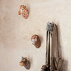 Colorful animal head wall decor featuring beige, brown, gray, and orange patterns for a playful touch.