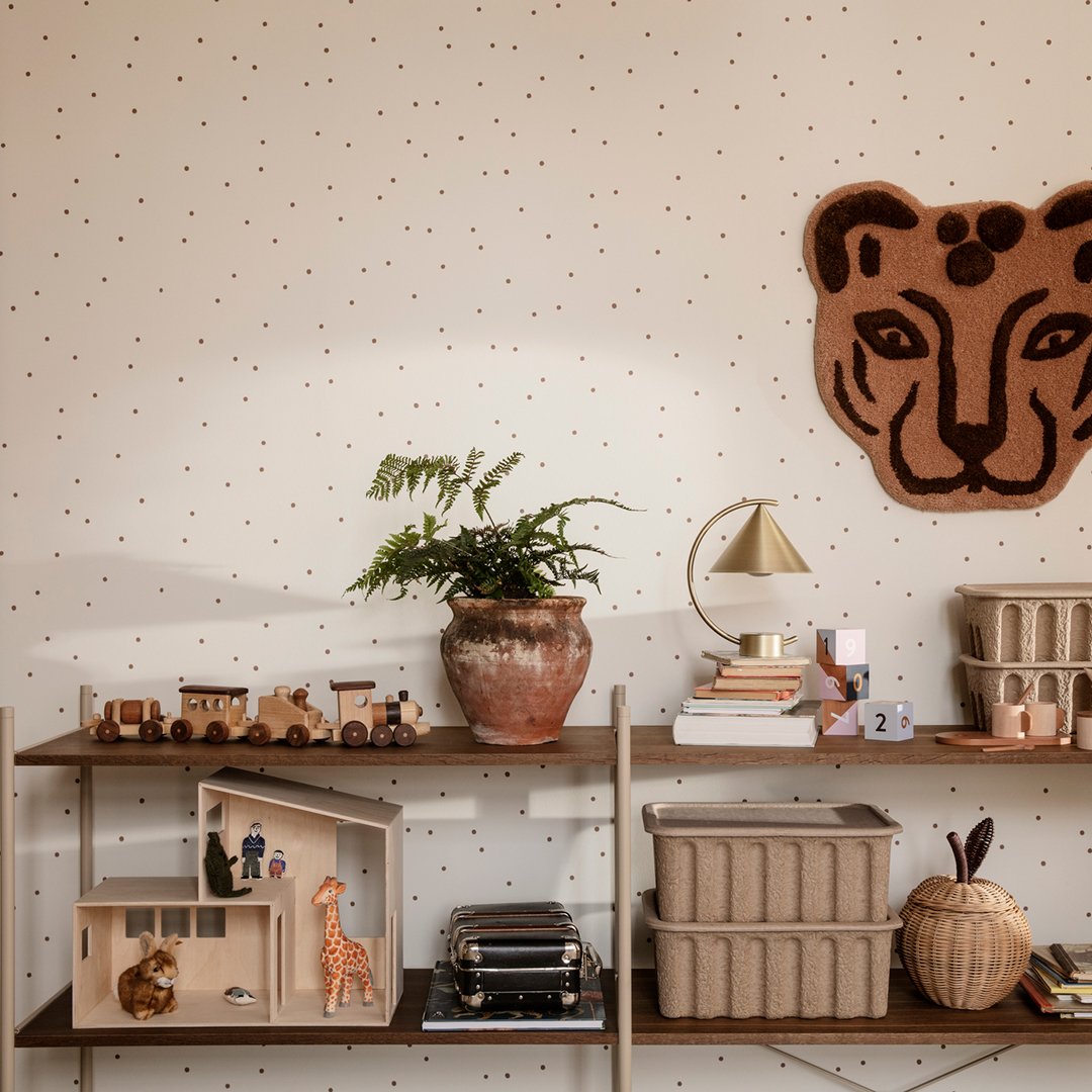 Neutral wall with colorful dots, brown leopard wall decor, earthy tones in planters and shelves, modern minimalist design.