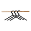 Black plastic hangers on a wooden rod, featuring a sleek, minimalist design. Perfect for organized closets.