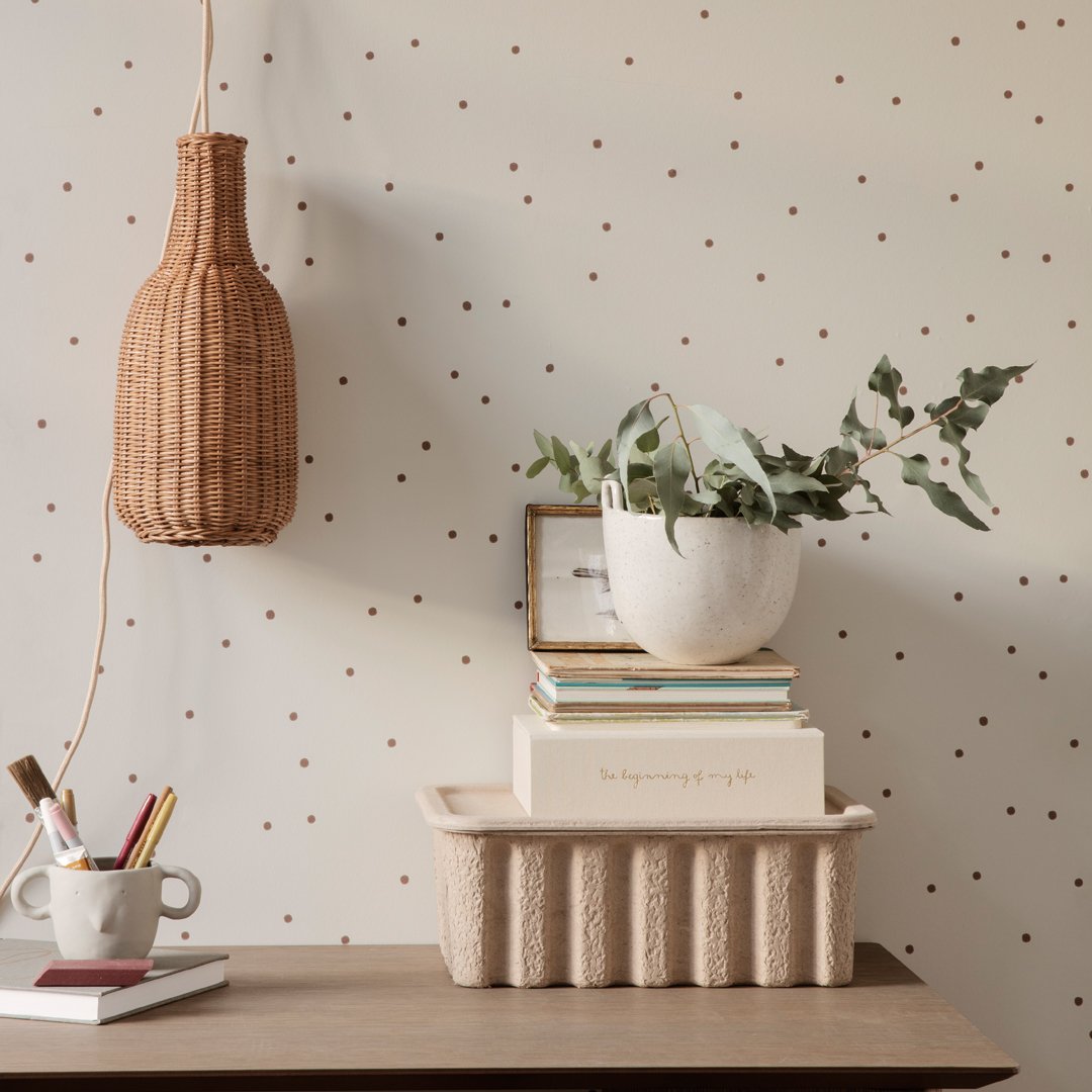 "Neutral tones with subtle polka dot pattern, featuring natural textures and greenery for a stylish decor accent."
