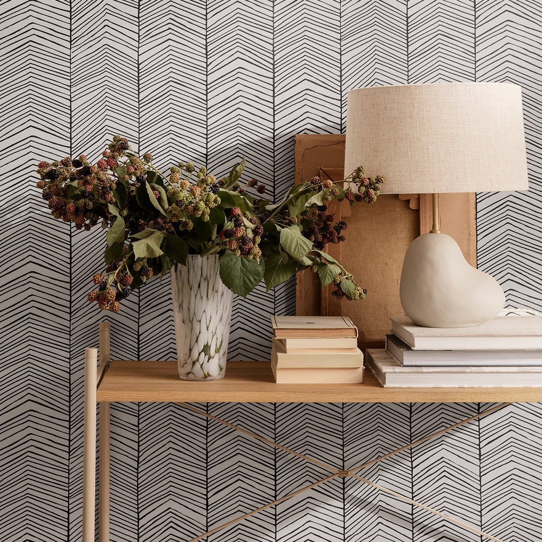 Black and white herringbone wallpaper pattern with a textured finish, perfect for modern decor accents.